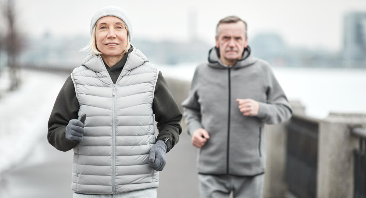 An elderly couple enjoying the winter after taking all safety precautions