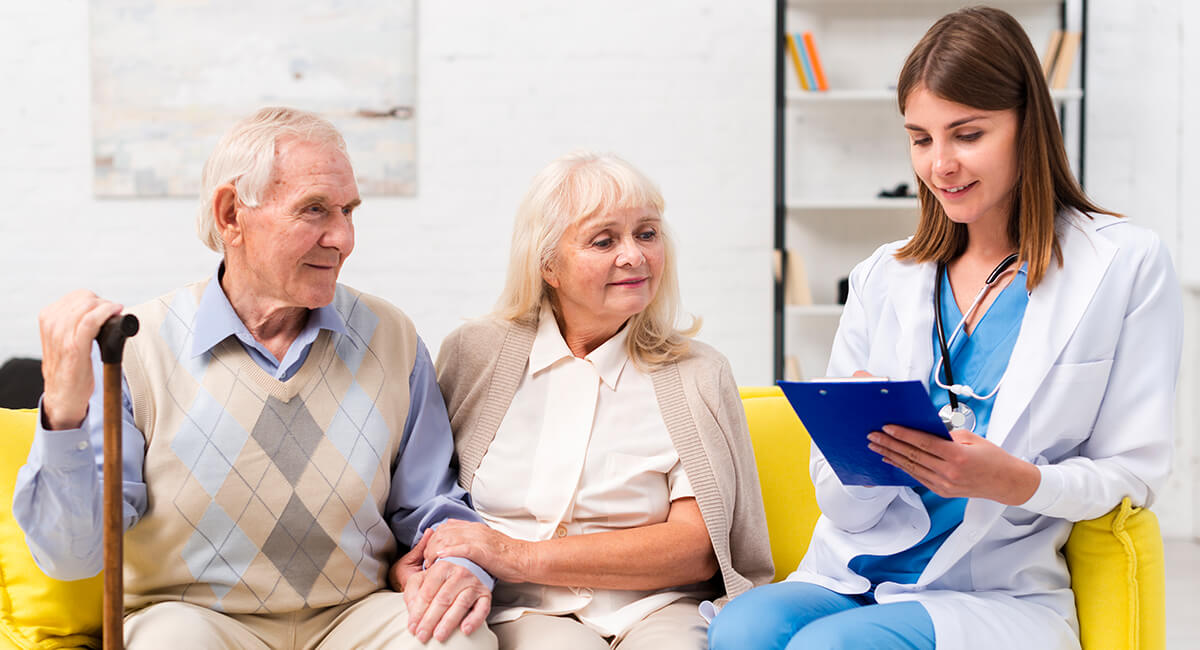 An in-home caregiver supporting an elderly couple live comfortably