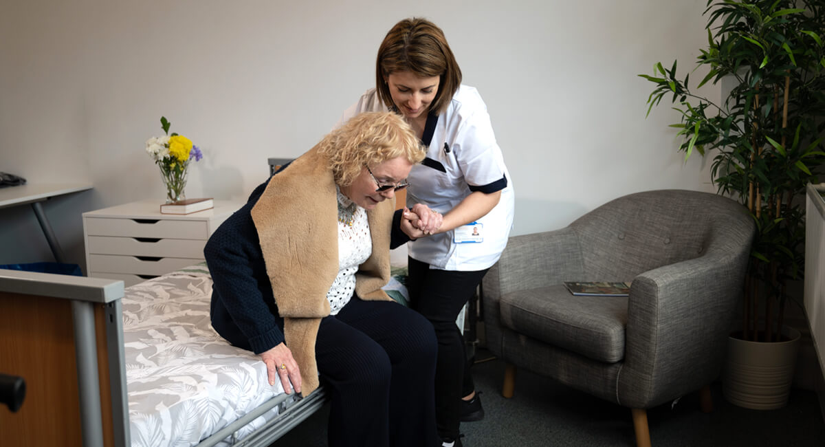 An in-home caregiver supporting an elderly couple live comfortably