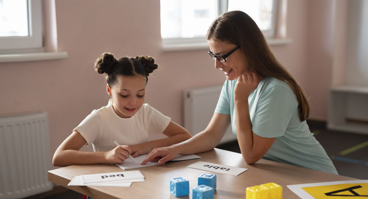 A learning disability nurse gives a little girl speech therapy.