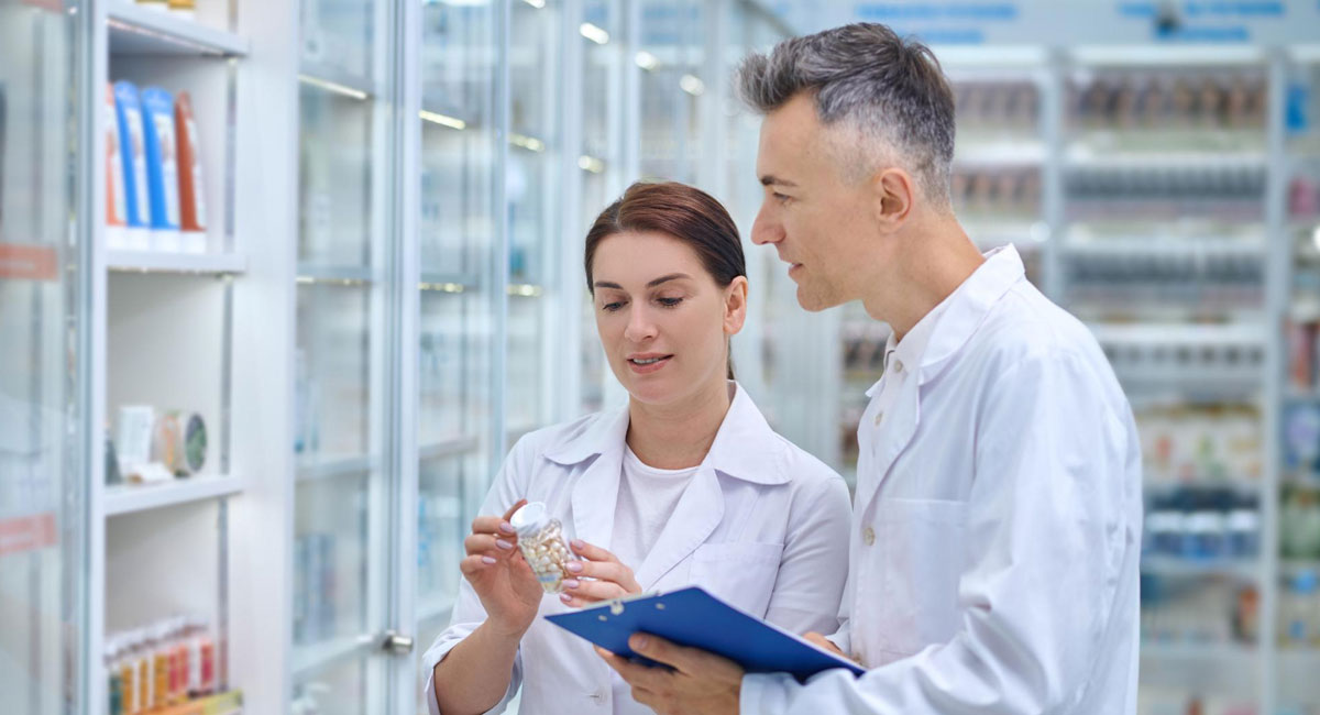 Two nurses reviewing medication administration records, ensuring patient safety