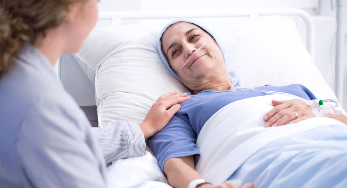 A senior receiving palliative care from a nurses group homecare carer