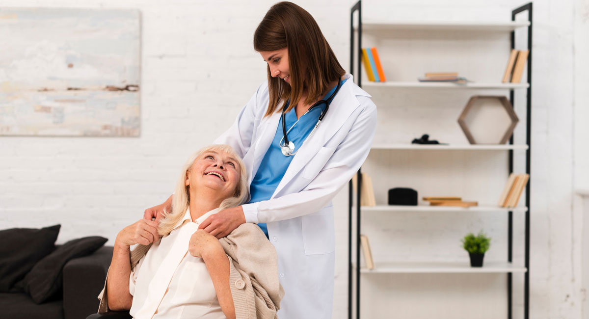 Compassionate caregiver offering respite support to a smiling elderly woman